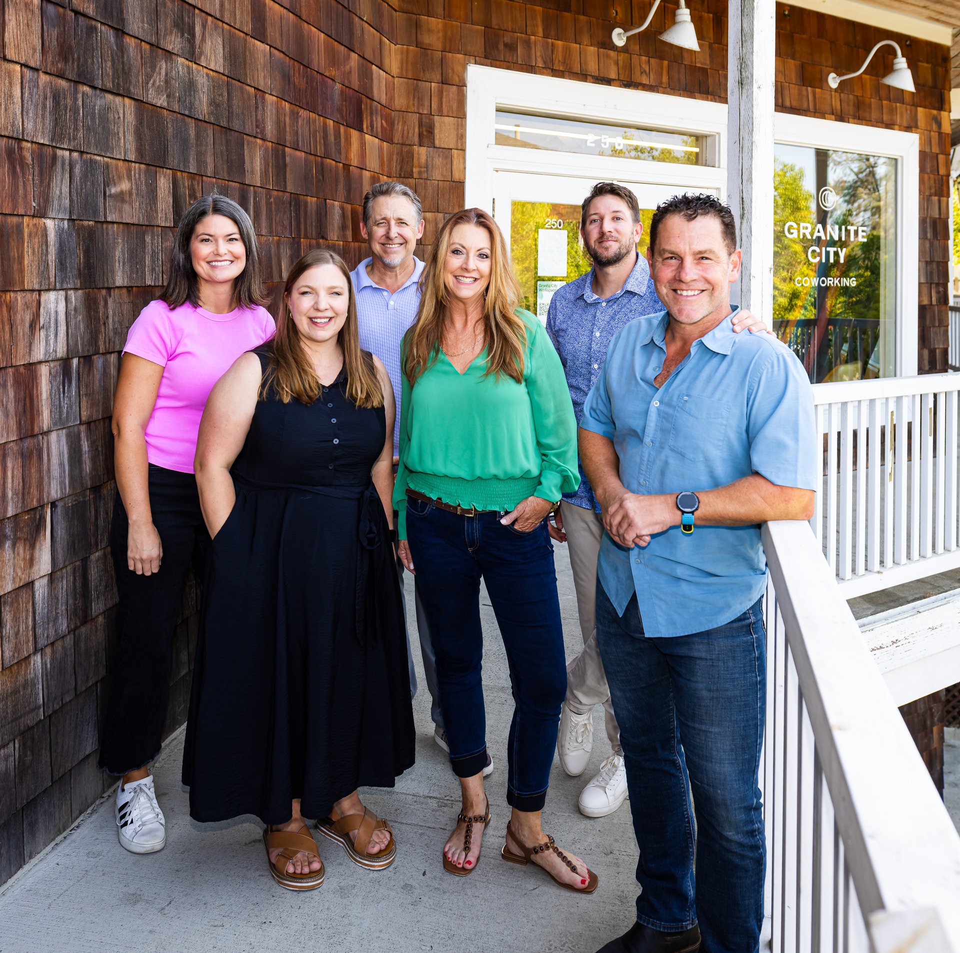 Six Goal House members smiling in front of the Granite City Coworking building