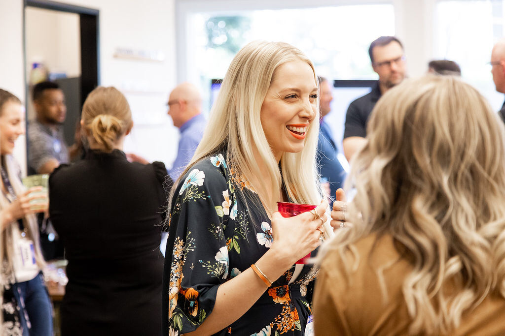 Attendee enjoying a drink and conversation at a Granite City networking mixer
