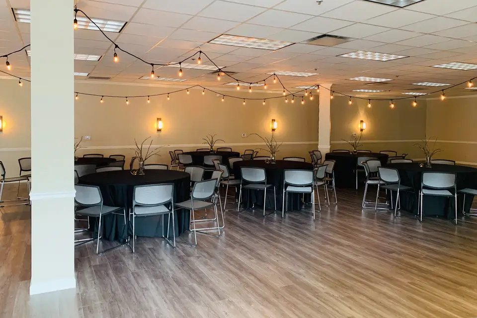 The Commons at Granite City set up for an event with round tables and string lights