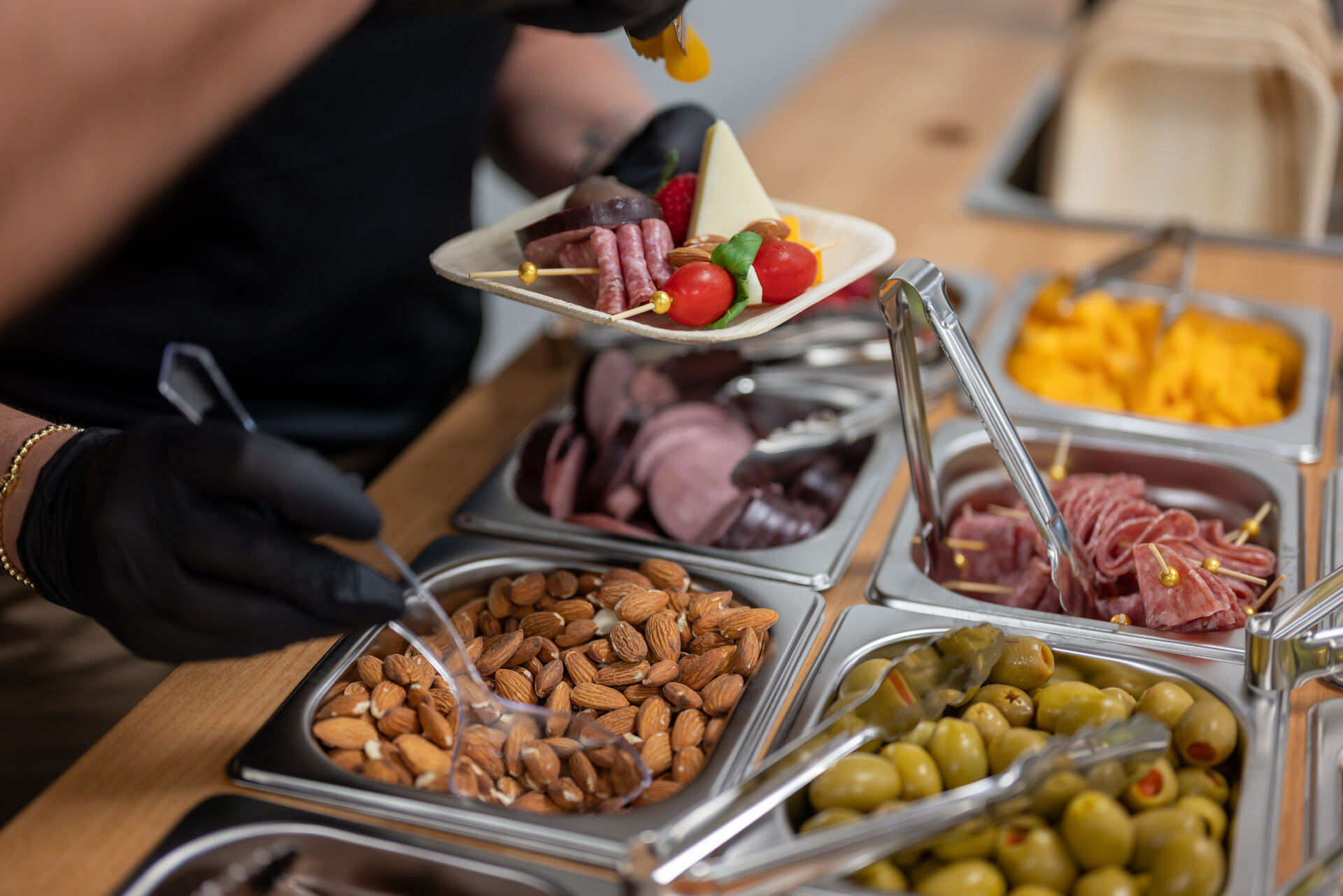 Charcuterie board being plated at a catered event at Granite City Workspaces in Folsom