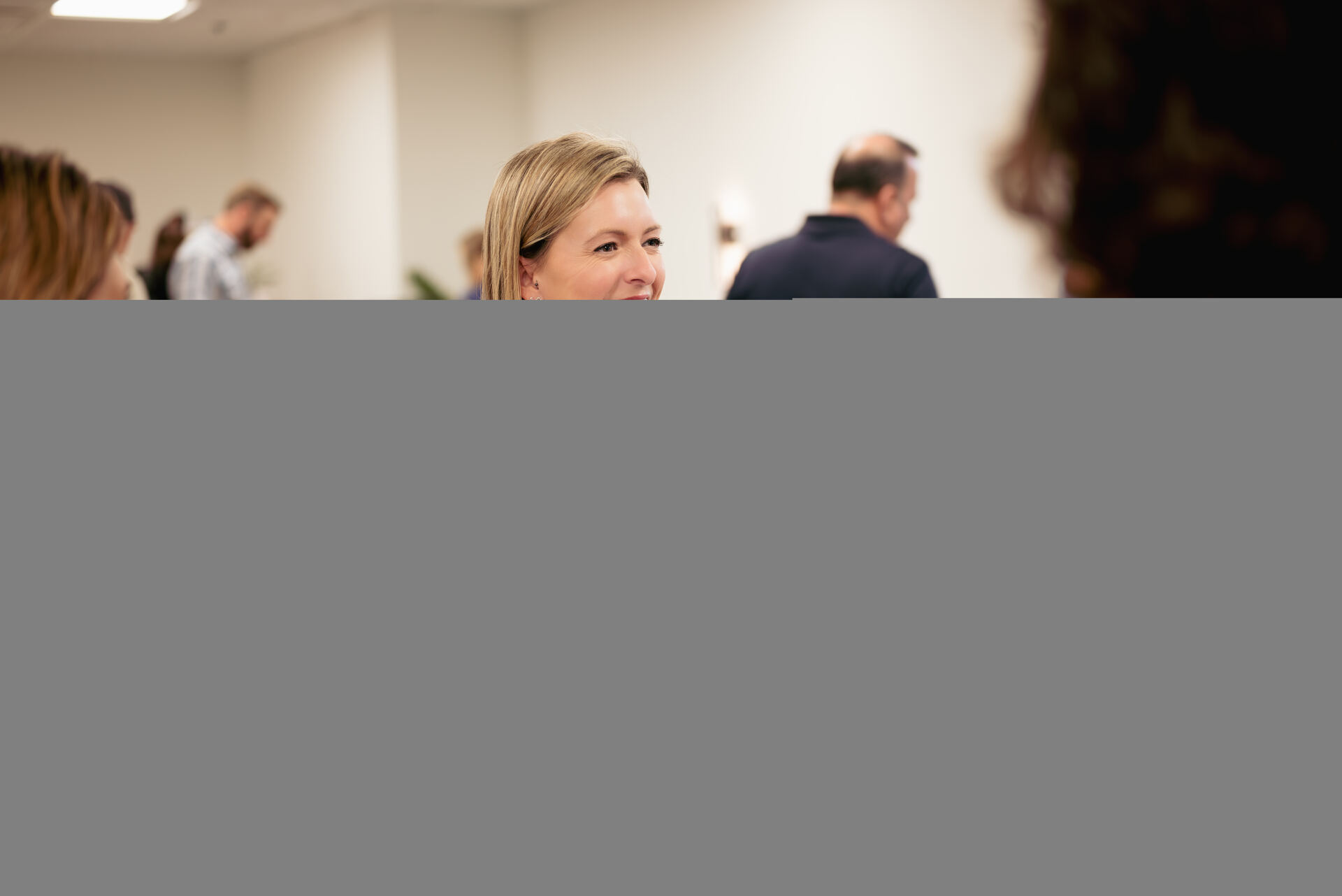 Attendee smiling in conversation at a Granite City networking event