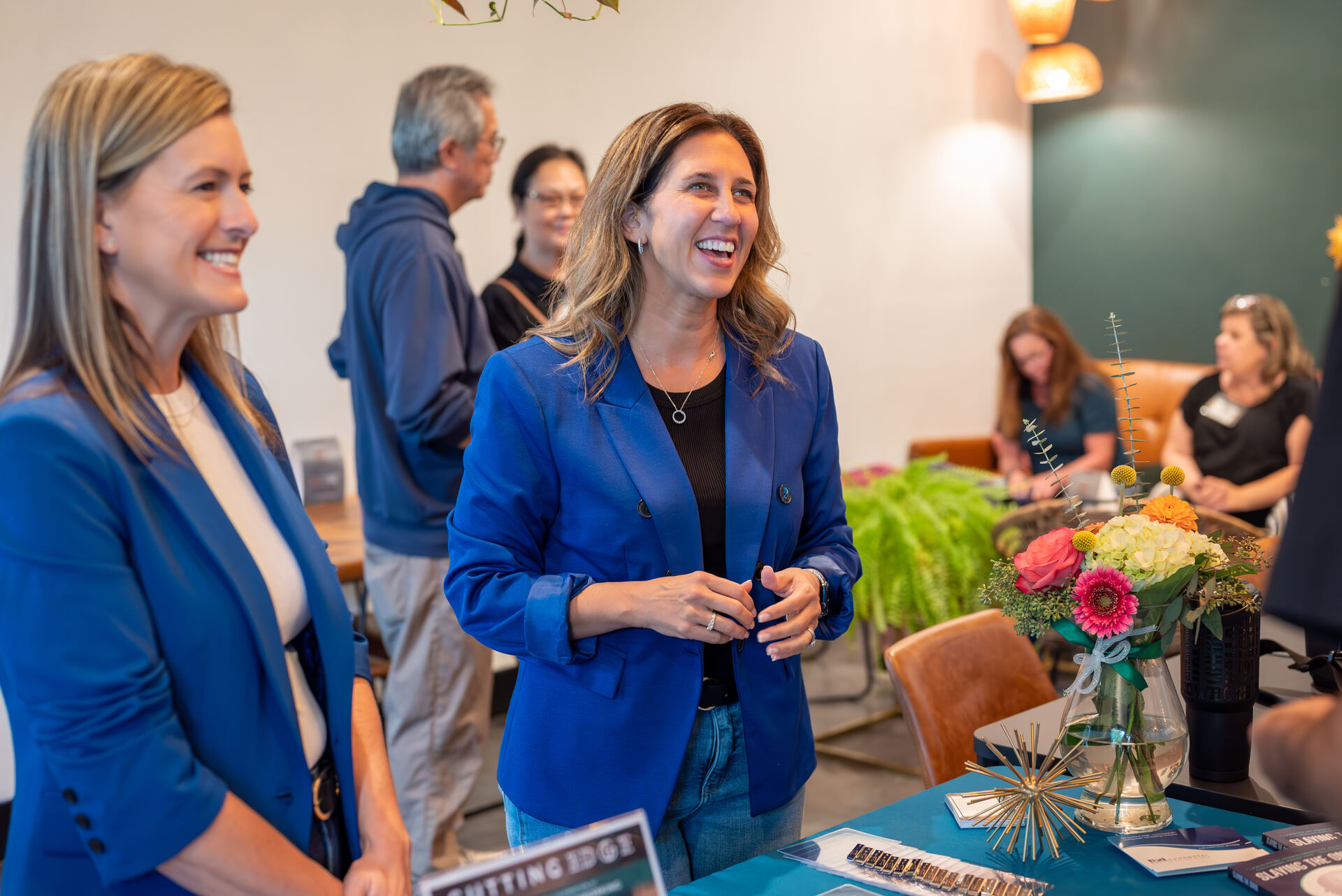 Two attendees laughing during a networking event at Granite City Workspaces in Folsom