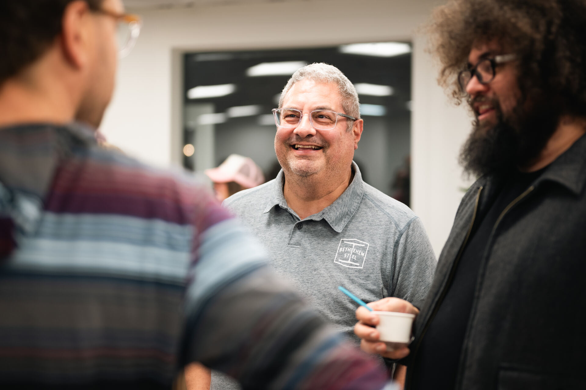 Members and guests chatting during a networking mixer at Granite City Workspaces